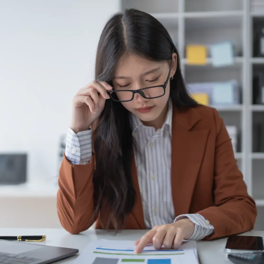 Female accountant reviewing financial documents at a desk